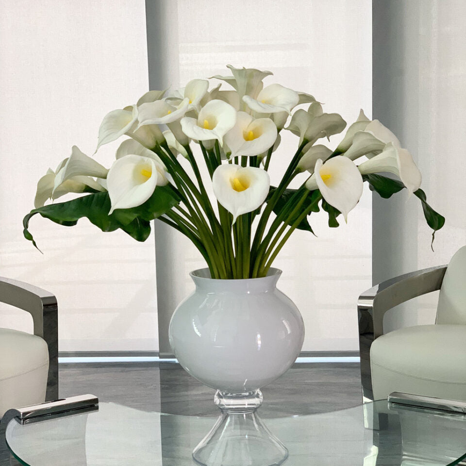 Refine vase with multiple white calla lilies